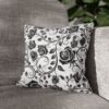 Black vintage roses throw pillow on sofa