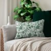 Green Roses Lumbar Pillow on couch