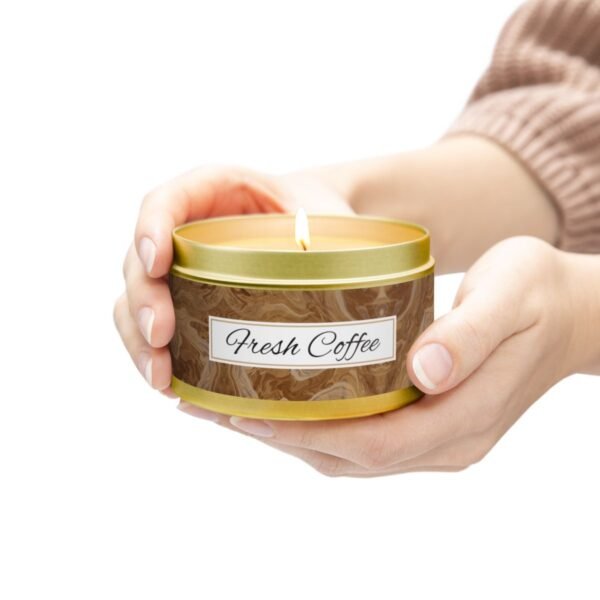 fresh coffee 8oz lit candle gold tin jar with hands holding candle