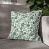 green roses pillow on couch