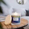 lavender fields wood wick lit candle sitting on wood table