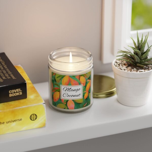 mango coconut lit candle clear jar sitting on shelf