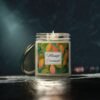 mango coconut lit candle clear jar with gray studio lighting