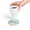 ocean breeze ceramic tile coaster round with hand holding coffee cup