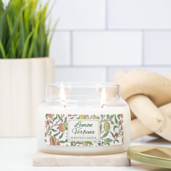 Lemon Verbena double wick lit candle in apothecary jar sitting counter Lemon Verbena double wick lit candle in apothecary jar sitting counter