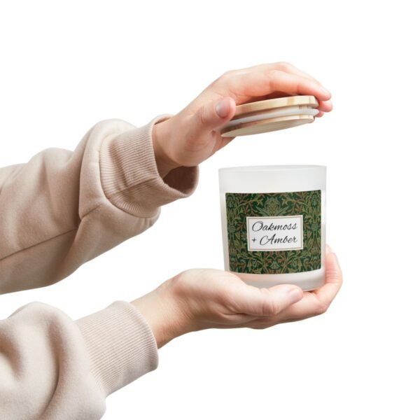Oakmoss Amber wood wick candle with hands holding candle and lid