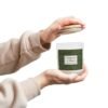 Oakmoss Amber wood wick candle with hands holding jar and lid Oakmoss Amber wood wick candle with hands holding jar and lid