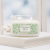 Woodland Reverie lit soy candle in 2 wick apothecary 12oz jar on in winter scene