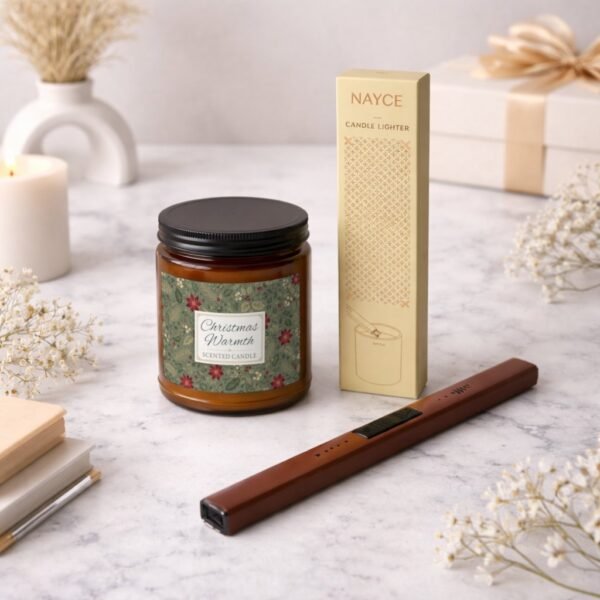 Christmas Warmth candle with electric lighter sitting on counter