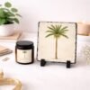 Coconut Cardamom Cream candle and palm tree printed on slate sitting on counter