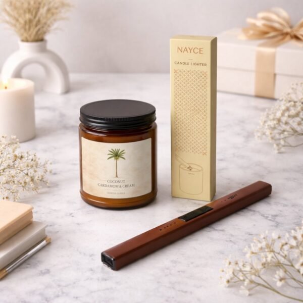 Coconut Cardamom Cream candle with electric lighter sitting on counter