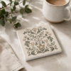 Botanical Motif ceramic tile coaster sitting on a table