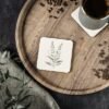 Tranquil Botanical square ceramic coaster on wood table Tranquil Botanical square ceramic coaster on wood table